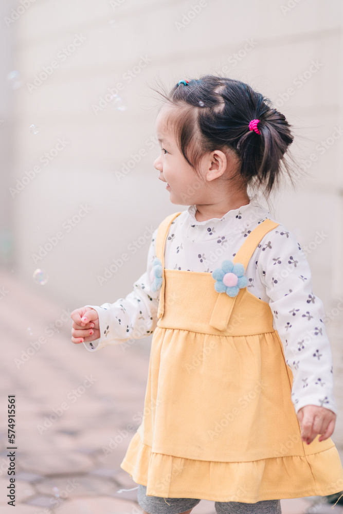 A cute happy little girl asian playing bubble outdoor. A cute happy little girl asian playing bubble outdoor.