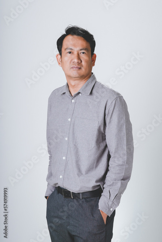 Asian businessman wearing gray shirt standing over isolated white background depressed and worry for distress, Sad expression. © 2p2play