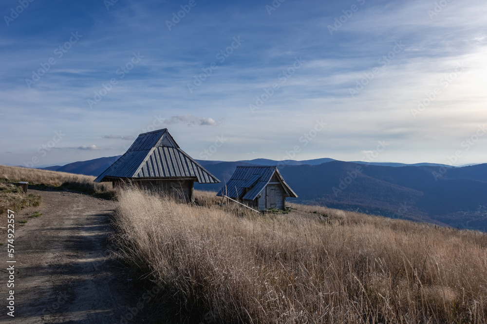 A wooden house in the Polish mountains among grass and hills - a landscape with the sky A wooden house in the Polish mountains among grass and hills - a landscape with the sky
