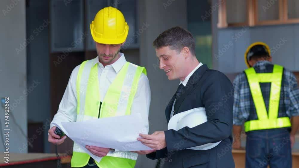 A team of engineers is discussing the structure to validate the building under construction. A team of engineers is discussing the structure to validate the building under construction.