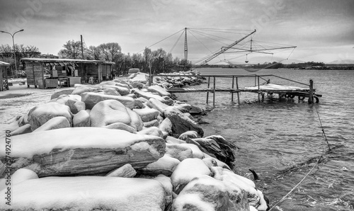 Typical fishing net and fisher house with over the sea in Marina di Pisa after a snowstorm - Tuscany, Italy photo