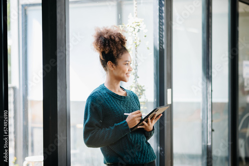 Confident female entrepreneur looking at the camera while standing. Young African woman standing in the boardroom of office. Free Download Confident female entrepreneur looking at the camera while standing. Young African woman standing in the boardroom of office. - GFXLoad
