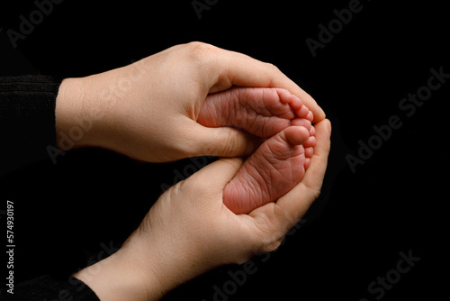 close-up of baby feet in mother's hands