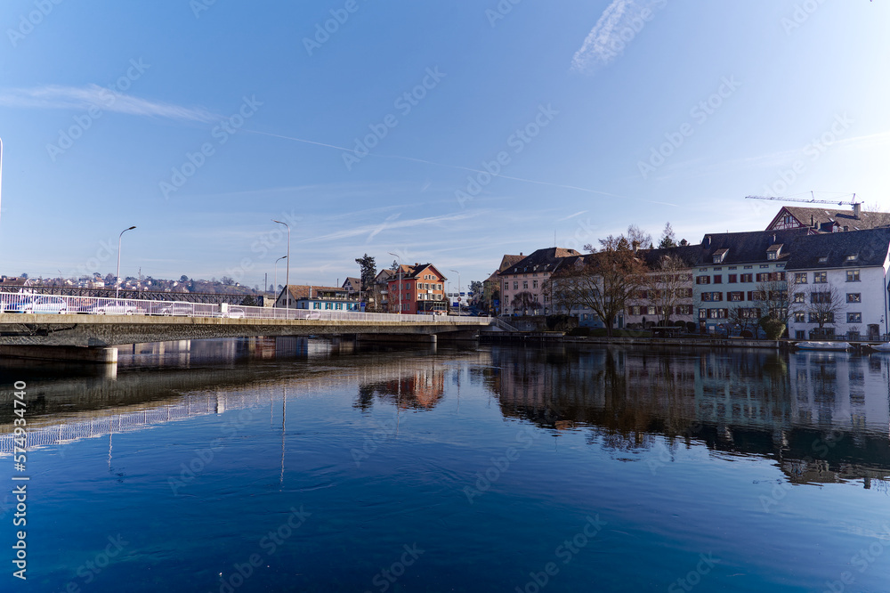 Scenic view of Rhine River at Swiss City of Schaffhausen with car bridge on a sunny winter day. Photo taken February 16th, 2023, Schaffhausen, Switzerland.