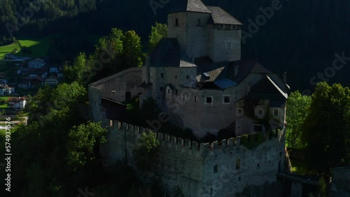Well-preserved Medieval Castle Reifenstein (Castel Tasso) In Campo di Trens, Bolzano, Italy. aerial ascend photo