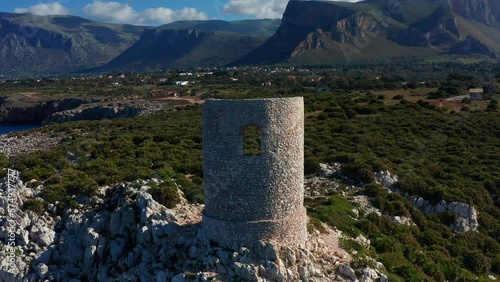 Torre Di Capo Rama, Coastal Defense Tower In Terrasini, Sicily, Italy. - aerial pullback photo