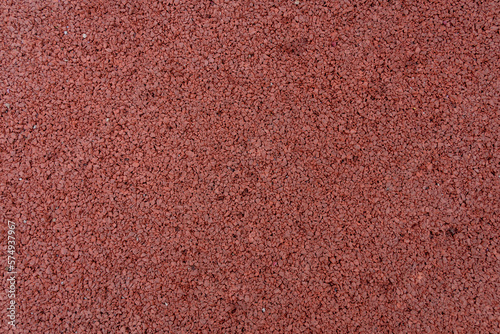 Close up of red rubber floor background. rubber flooring for sports and playgrounds, Running racetrack, tennis court.