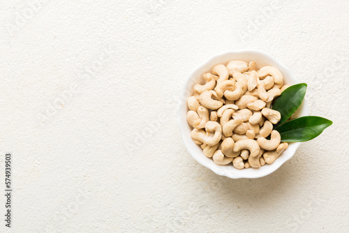 cashew nuts in wooden bowl on table background. top view. Space for text Healthy food