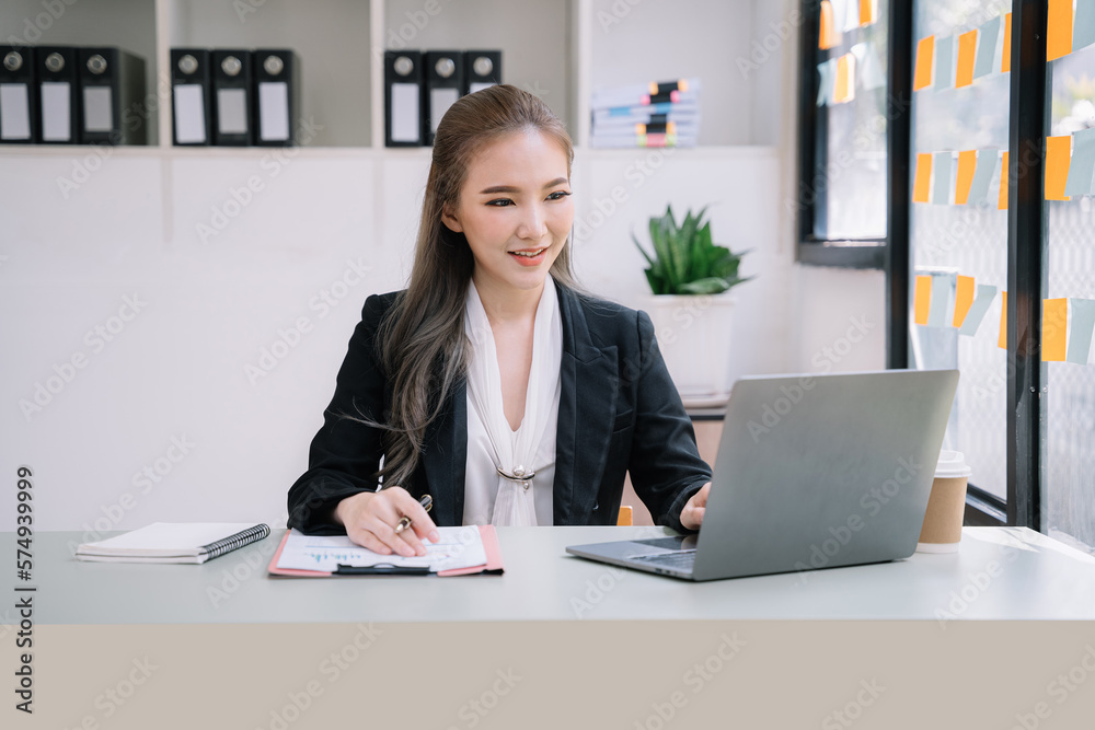 Female writes information businessman working on laptop computer writing business plan while sitting in office. Female writes information businessman working on laptop computer writing business plan while sitting in office.