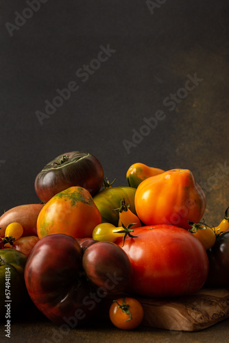 Ripe juicy colorful tomatoes of different varieties close-up, organic seasonal products from the market, farm harvest