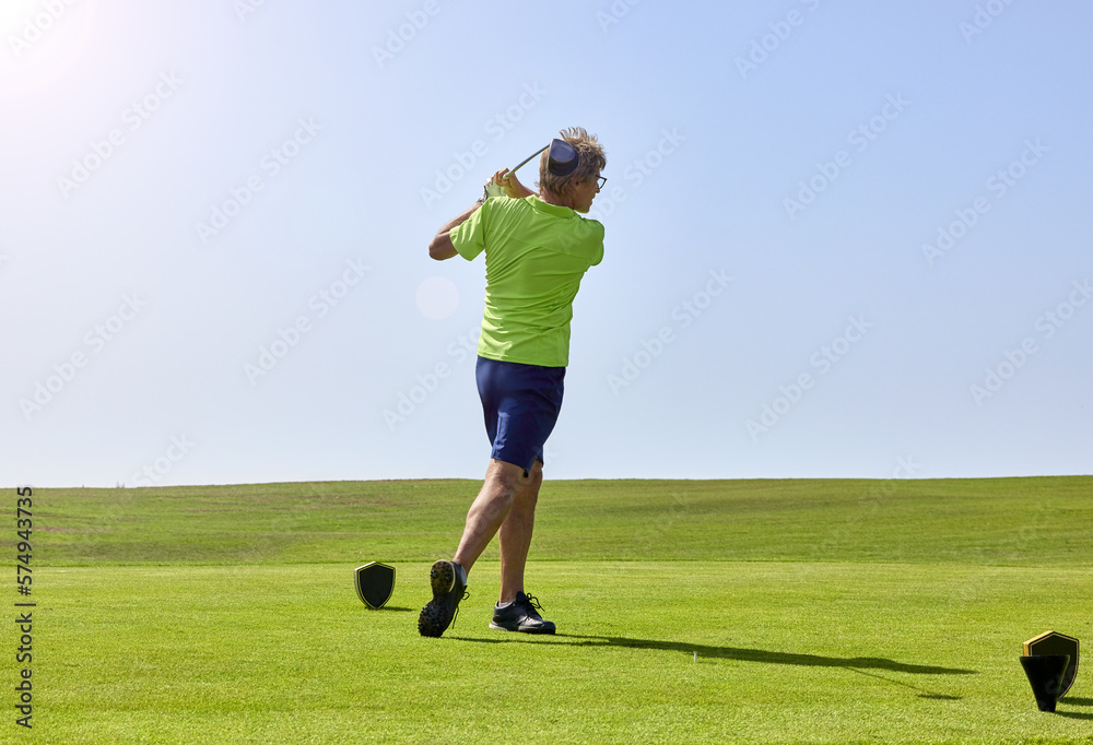 Golfer on a golf course, ready to tee off. Golfer with golf club hitting the ball for the perfect shot. Golfer on a golf course, ready to tee off. Golfer with golf club hitting the ball for the perfect shot.