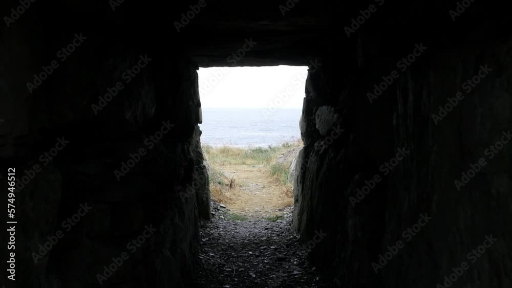 First-person walk through a stone tunnel leading to the Irish seashore First-person walk through a stone tunnel leading to the Irish seashore