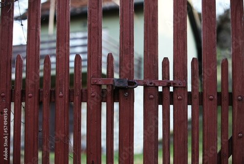 Red wooden gate with padlock, decorated gate, as background