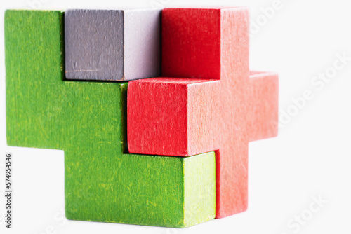 Colorful wooden cube puzzle on the white table. Geometric shapes in different colors. Logical tasks.
