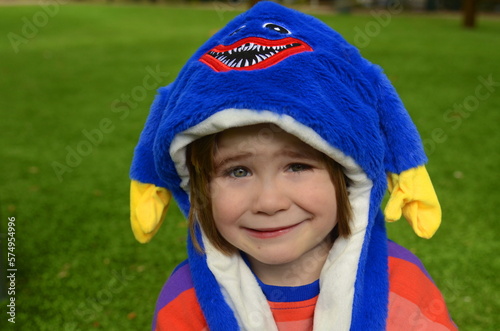Purim, Halloween. Cute boy in a funny hat with ears. The smile of a child, a festive mood. A boy in a carnival costume. Portrait of a child in a festive headdress.