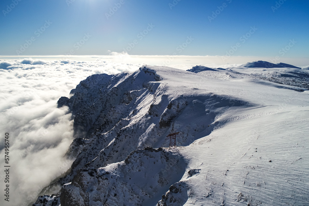 Winter landscape in Bucegi Mountains. Landmarks of Romania, beautiful view with cliffs covered with snow, aerial nature landscape photo.