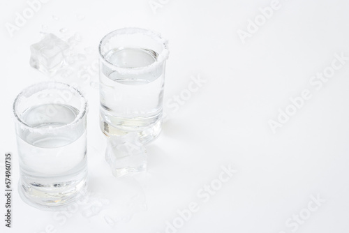 Glasses of tequila with lime and salt. Strong alcohol background