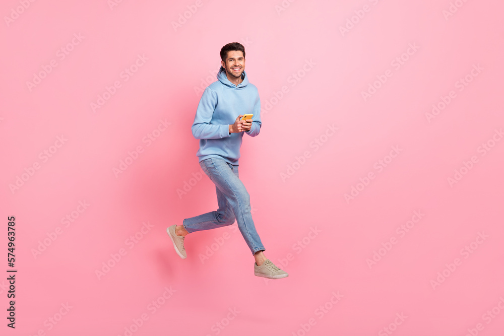 Full length photo of positive stylish man user moving empty space sale modern devices gadgets isolated on pink color background Full length photo of positive stylish man user moving empty space sale modern devices gadgets isolated on pink color background