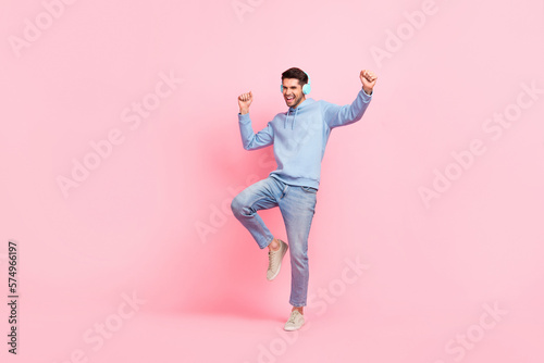 Full body cadre of young positive energetic dancer student guy wear new apple airpods pro best music sound quality isolated on pink color background