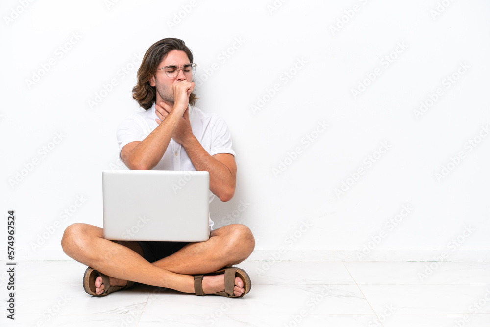 Young handsome man with a laptop sitting on the floor isolated on white background is suffering with cough and feeling bad Young handsome man with a laptop sitting on the floor isolated on white background is suffering with cough and feeling bad