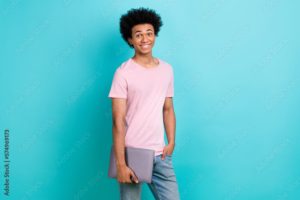 Photo of optimistic satisfied young guy student hold netbook enjoy his freelance job working remote online isolated on aquamarine color background
