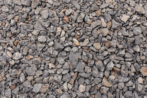 Crushed stone close up. Crushed stone construction materials. Small stones ground. Small stone construction material. Background, texture of stones. 