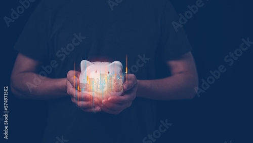 saving and investment concept, man holding piggy bank with virtual graph and blurred stacking of coins photo