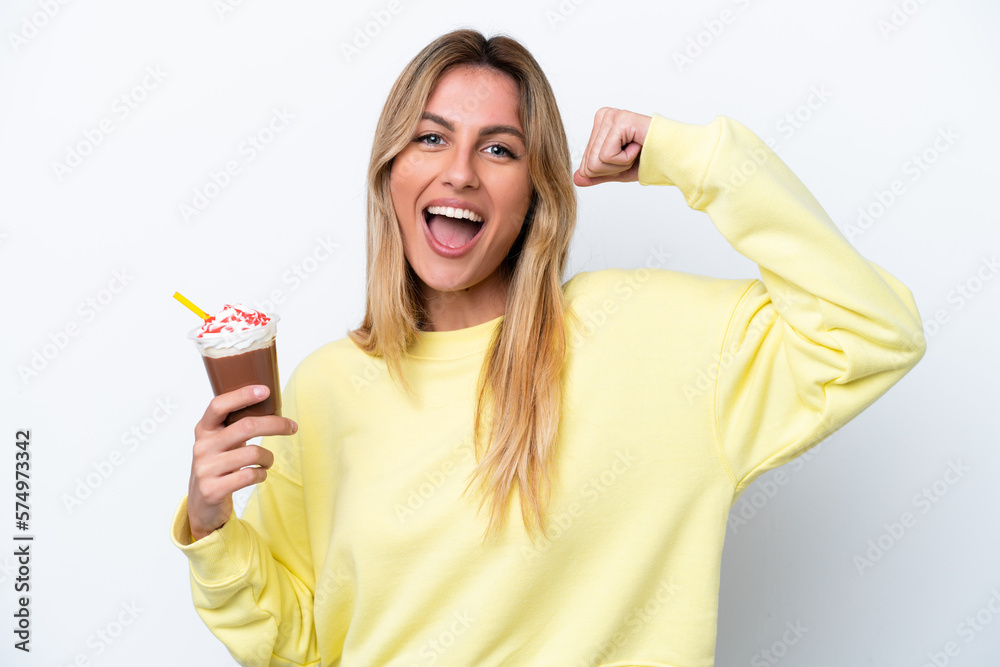 Young Uruguayan woman holding Frappuccino isolated on white background doing strong gesture Young Uruguayan woman holding Frappuccino isolated on white background doing strong gesture