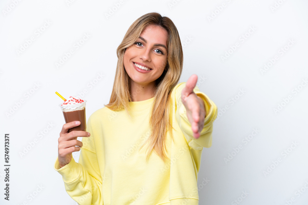 Young Uruguayan woman holding Frappuccino isolated on white background shaking hands for closing a good deal Young Uruguayan woman holding Frappuccino isolated on white background shaking hands for closing a good deal