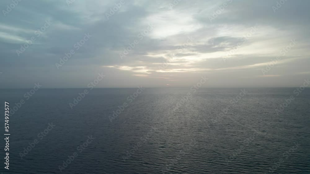 View of the clouds over the sea at sunrise. Blues mix with oranges, golden hour. View of the clouds over the sea at sunrise. Blues mix with oranges, golden hour.