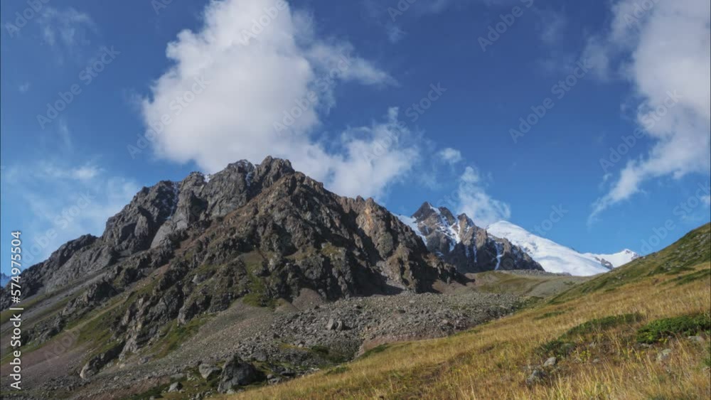 The movement of clouds over a mountain peak. Timelapse