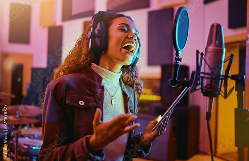 Tablet, music and woman singing in a studio for radio, song production and rehearsal. Creative, voice and a singer making a record, track or recording a musical sound as a professional artist