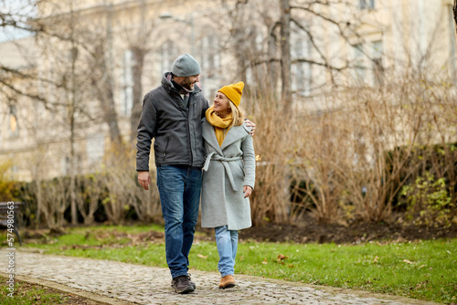 Embraced romantic couple enjoying a walk in the park © Stockphotodirectors