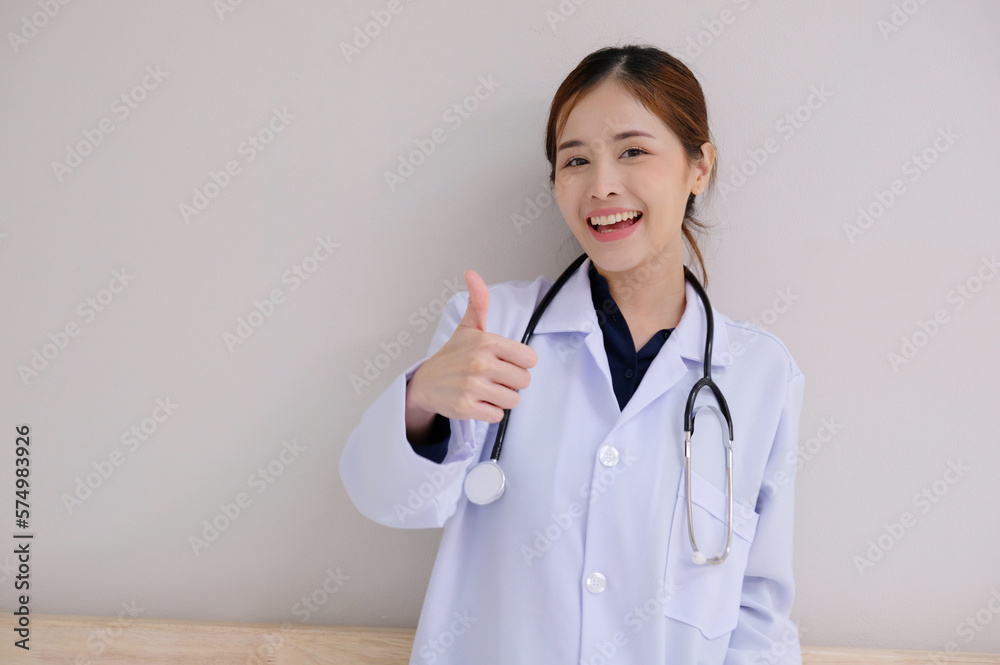 Asian female doctor wearing a white lab coat smiling on a white background. Asian female doctor wearing a white lab coat smiling on a white background.