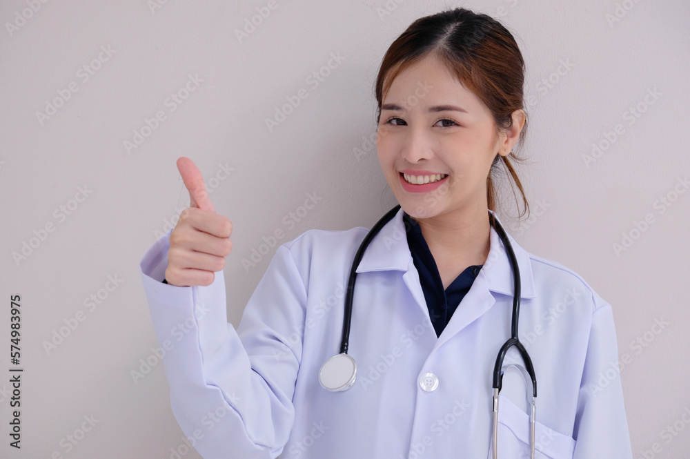 Asian female doctor wearing a white lab coat smiling on a white background. Asian female doctor wearing a white lab coat smiling on a white background.