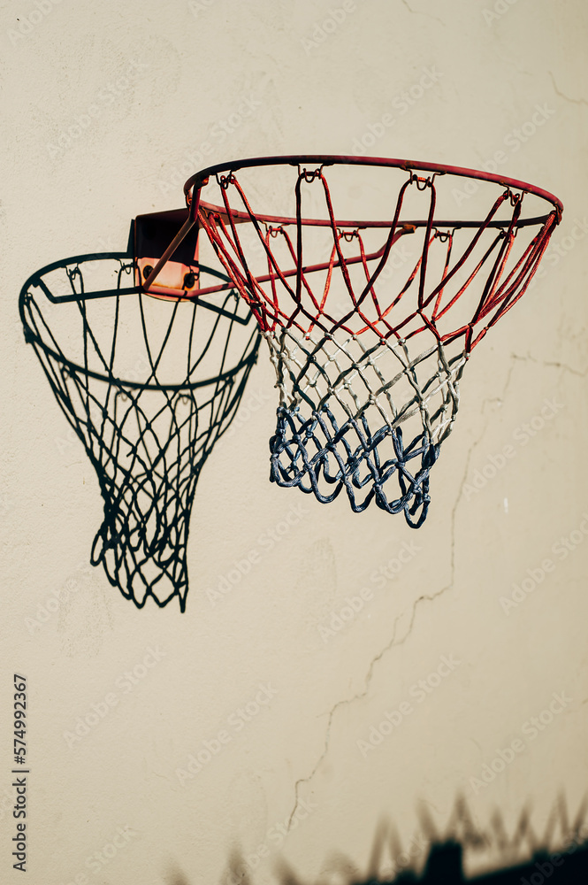 Basketball net on wall in sun