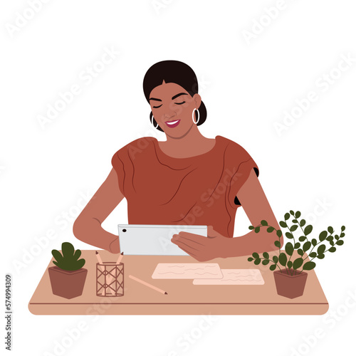 An accountant works in finance. Young smiling African American woman holding a tablet PC, paper. A beautiful business lady is working at the office desk.