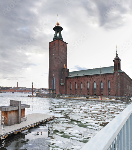 view of stockholm city hall stadhuset from the frozen river with melting ice photo