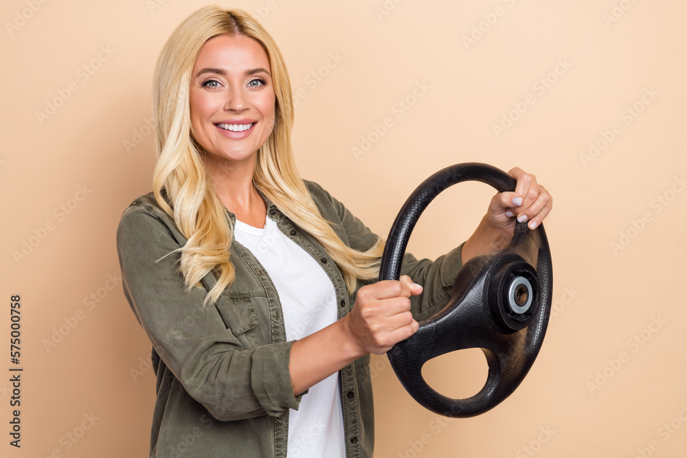 Photo of positive lovely lady wear trendy clothes buy new own car repair maintain service app isolated on beige color background Photo of positive lovely lady wear trendy clothes buy new own car repair maintain service app isolated on beige color background