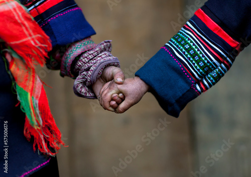 Black hmong kids holding each other s hand, Sapa, Vietnam photo