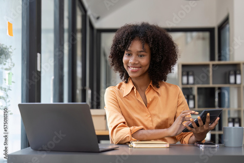 Accountant black woman working on laptop and do document, tax, exchange, accounting and Financial advisor concept © Natee Meepian