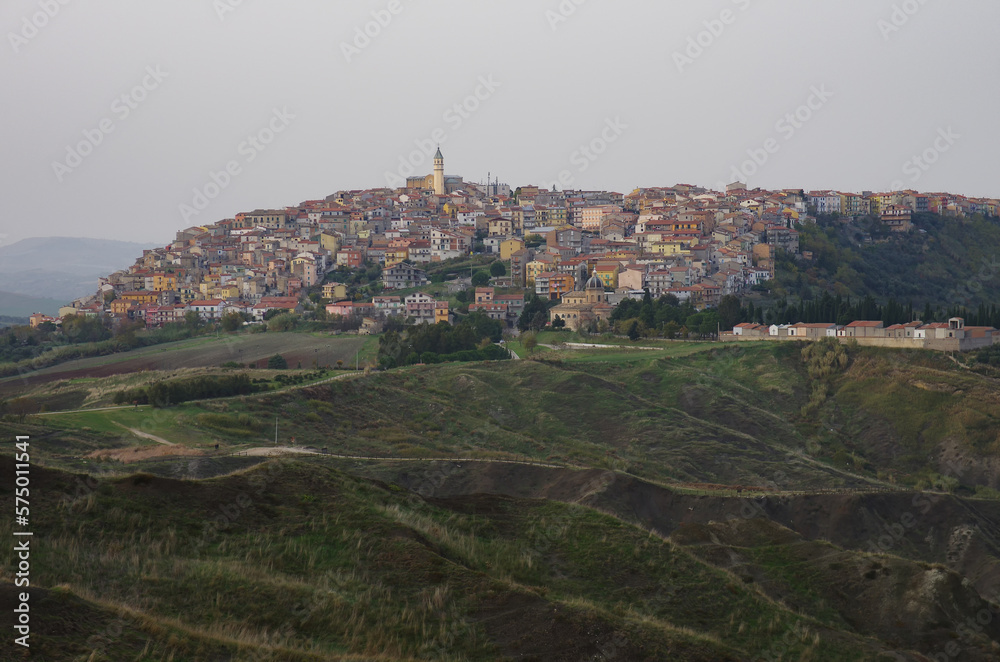 Obraz premium The landslide system with the gullies and in the background Montenero di Bisaccia, a small town in the lower Molise region, Italy
