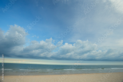 Beautiful white clouds on blue sky over calm sea with sunlight reflection. Tranquil sea harmony of calm water surface.