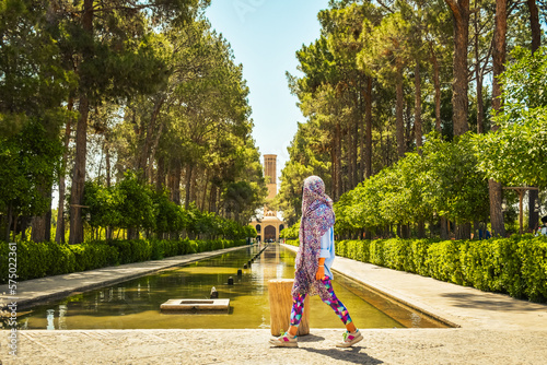 Female tourist visit famous sightseeing attraction in Dowlat Abad Garden , Yazd , Iran photo