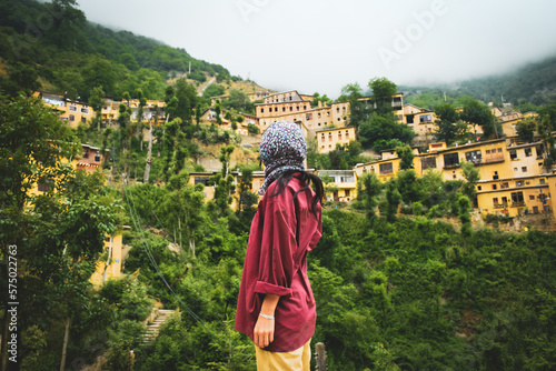 Tourist woman stand enjoy scenic Masuleh village panorama in north east Iran - popular famous tourism destination in persia photo