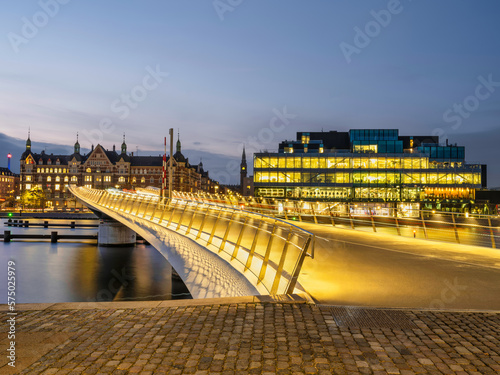 Lille Langebro cycle and pedestrian bridge over the city harbour lit up after sunset in Copenhagen, Denmark photo