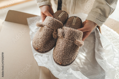 Home soft slippers in a box, unpacking photo