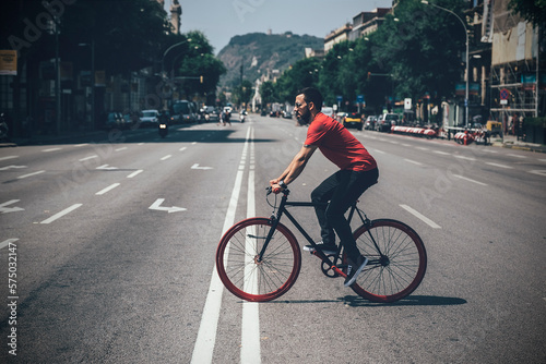 Man crossing street on bicycle