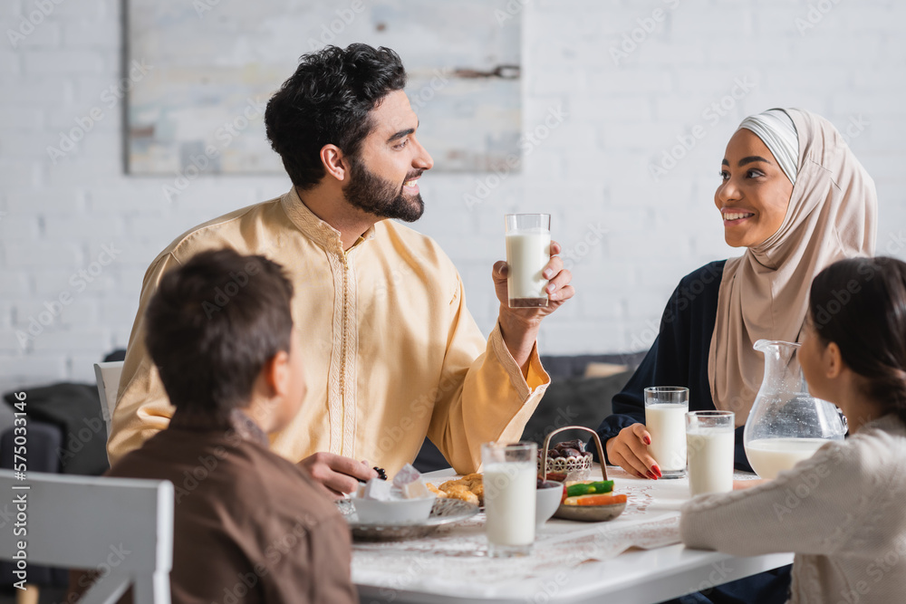 Smiling middle eastern family talking during ramadan breakfast at home. Smiling middle eastern family talking during ramadan breakfast at home.