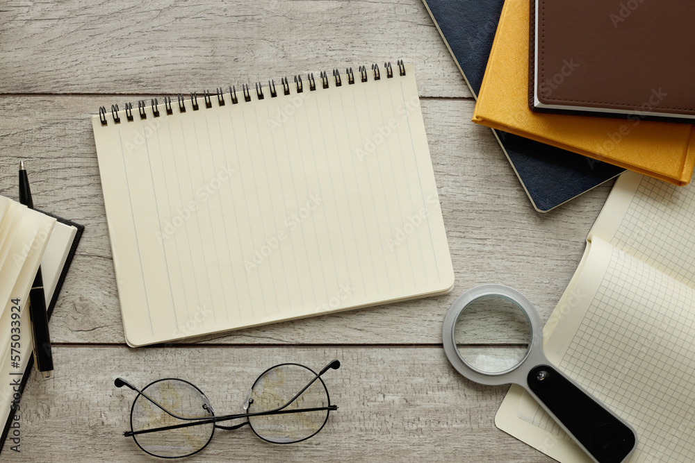 Blank notepad ready for mockup on wooden table, top view, flat lay.